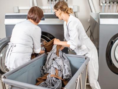 Two women doing laundry operations